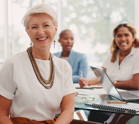 Bloomfield Hills patient smiling at work with dentures