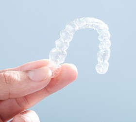 Patient holding clear aligner