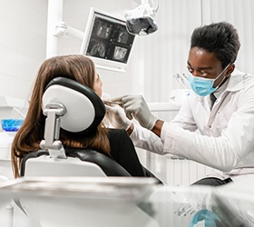 Dentist looking in a patient’s mouth