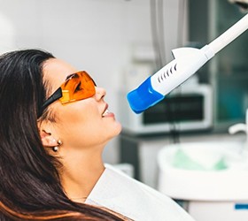 A woman receiving teeth whitening.