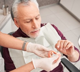 Man holding dentures