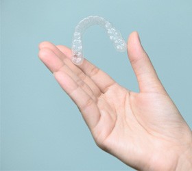 Patient holding clear aligner