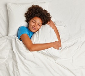 Woman sleeping with sleep apnea in Bloomfield Hills