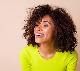 Woman in neon green shirt smiling