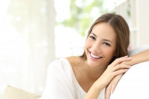 A woman smiling after cosmetic dental treatment.