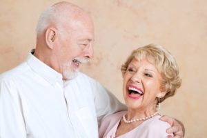 older couple smiling and hugging