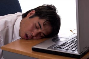 man sleeping at desk mouth open