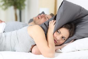 husband snoring, wife annoyed