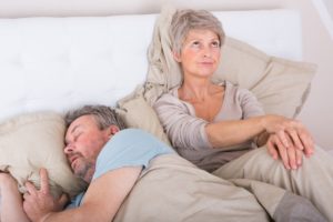 woman upset with man snoring loudly