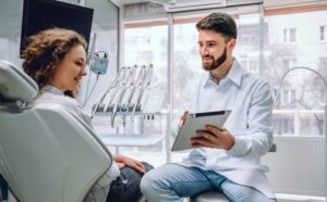 dentist showing a patient the results of their cavity detection system 