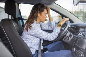 woman falling asleep at the wheel due to drowsy driving 