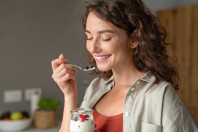 woman eating jar of yogurt in Bloomfield Hills