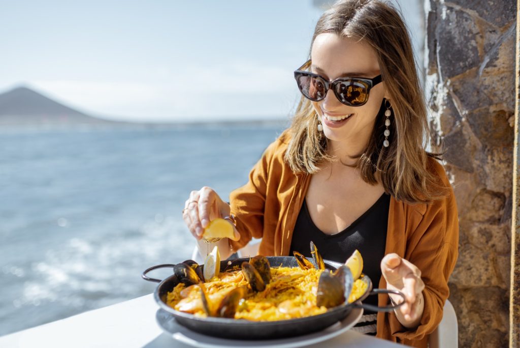 Woman smiling while eating lunch on vacation