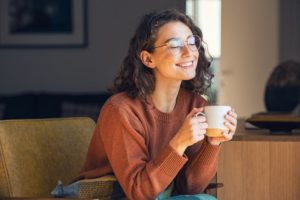 a woman drinking green tea to keep her gums healthy